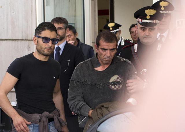 L'attentatore, Luigi Preiti, esce dal pronto soccorso accompagnato dai carabinieri. Ansa